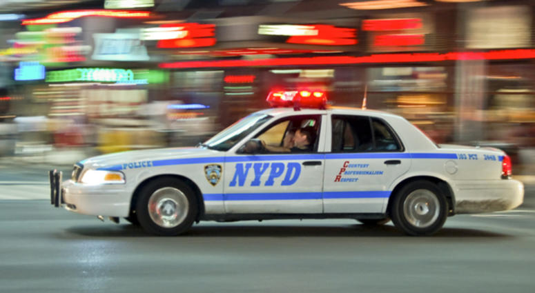 A NYPD car speeding in Manhattan NYPD car