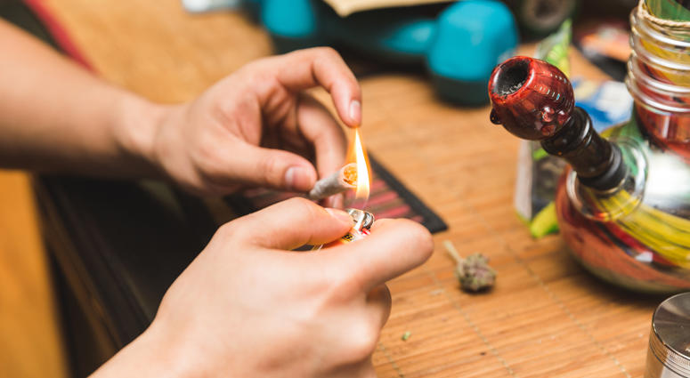 Lighting a marijuana joint. Marijuana joint