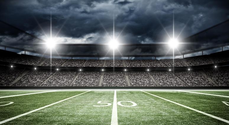 A football field under stadium lights