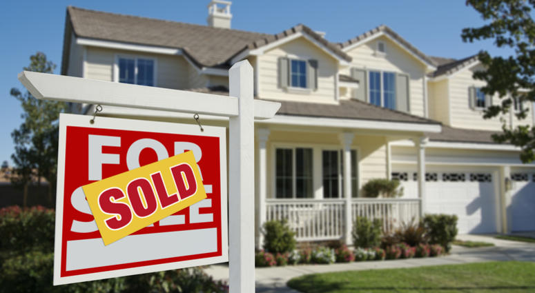 Sold Home For Sale Sign in Front of New House Sold Home For Sale Sign in Front of New House