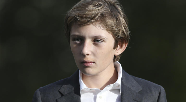 Barron Trump waits for President Donald Trump while he speaks to reporter on the South Portico of the White House in Washington D.C., on November 21, 2017. Barron Trump