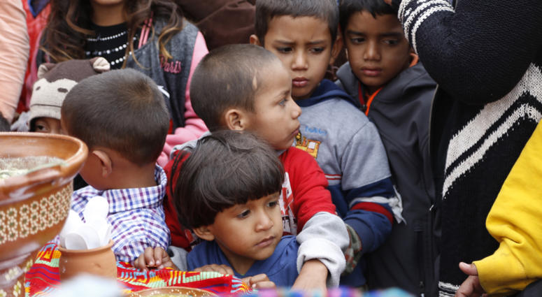 Children wait in line for a plate of food in Tijuana, Baja California, Mexico. Migrant children