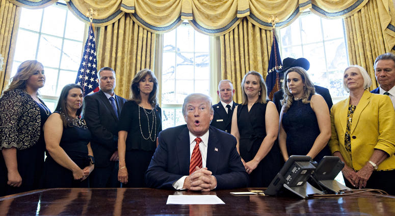 U.S. President Donald Trump, center, speaks while meeting with the crew and passengers of Southwest Airlines Co. flight 1380 in the Oval Office of the White House in Washington, D.C., U.S., on Tuesday, May 1, 2018. President Trump Meets With Crew And Passengers Of Southwest Airlines Flight 1380 At The White House