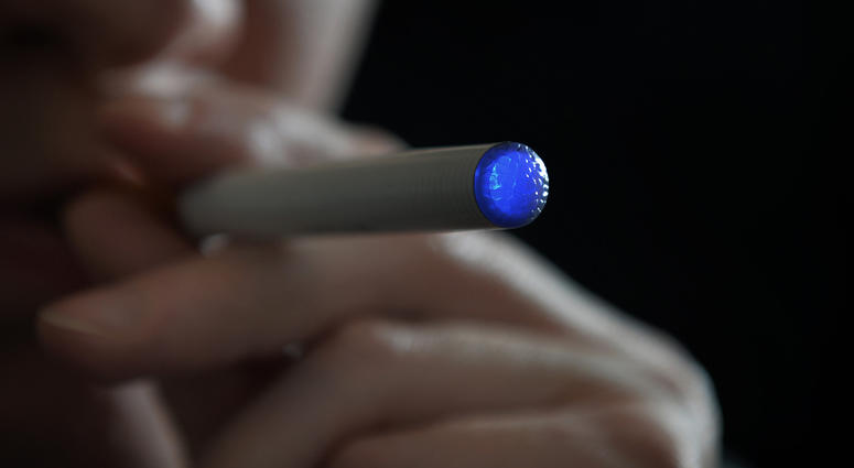 person smoking an e-cigarette e-cigarette