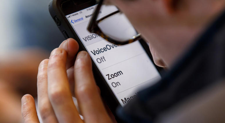 A customer uses the accessibility features of an iPhone iPhone user