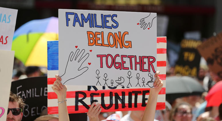A protester holds a placard during the "Families Belong Together" rally at Daley Plaza in Chicago, the United States, on June 30, 2018. Families Belong Together Protest