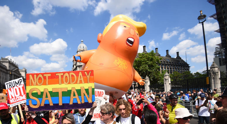 The "Trump Baby" balloon joins demonstrators as they march through Parliament Square in London, as part of the protests against the visit of US President Donald Trump to the UK Baby Trump Balloon
