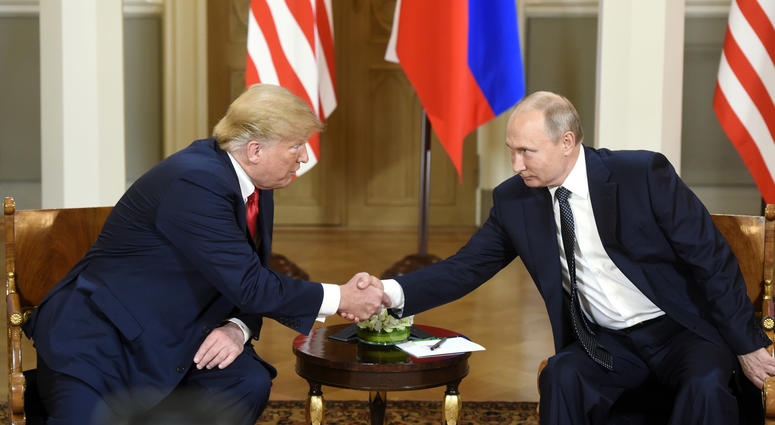 U.S. President Donald Trump (L) shakes hands with his Russian counterpart Vladimir Putin in Helsinki, Finland, on July 16, 2018. Donald Trump, Vladimir Putin