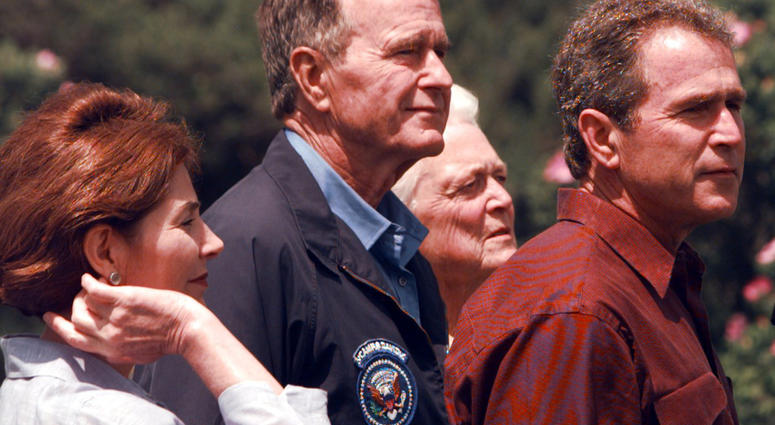 George W. Bush (right) takes questions during a brief photo opportunity as Barbara Bush, George H.W. Bush and wife Laura Bush look on during a brief photo opportunity at Walker's Point Kennebunkport, Maine, June 13, 1999. George H.W. Bush