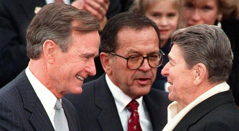 President Ronald Reagan greets newly-inaugurated president George H.W. Bush during Bush's swearing-in ceremony, January 20, 1989, in Washington, D.C. George H.W. Bush