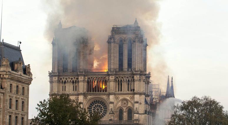 Flames rise from Notre Dame Cathedral as it burns in Paris, Monday, April 15, 2019 Notre Dame Fire