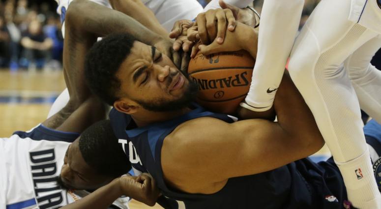 Loose ball scramble has Karl-Anthony Towns holding on Karl-Anthony Towns of the Wolves