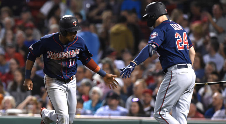 Sep 3, 2019; Boston, MA, USA; Minnesota Twins shortstop Jorge Polanco (11) is congratulated by first baseman C.J. Cron (24) after scoring a run against the Boston Red Sox during the third inning at Fenway Park.