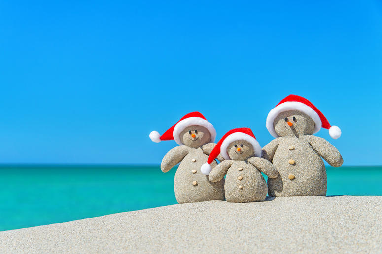 Christmas Snowmen in santa hats at tropical beach Christmas Snowmen in santa hats at tropical beach
