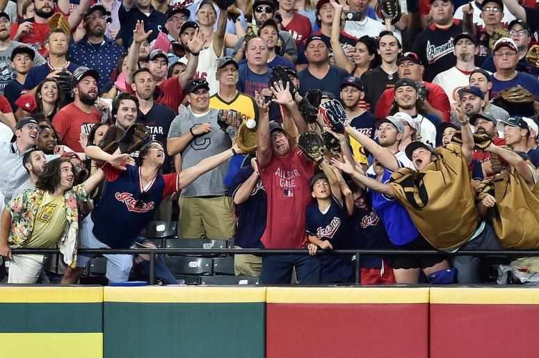 Fans reach for a home run during the second round in the 2019 MLB Home Run Derby at Progressive Field. Fans reach for a home run during the second round in the 2019 MLB Home Run Derby at Progressive Field.
