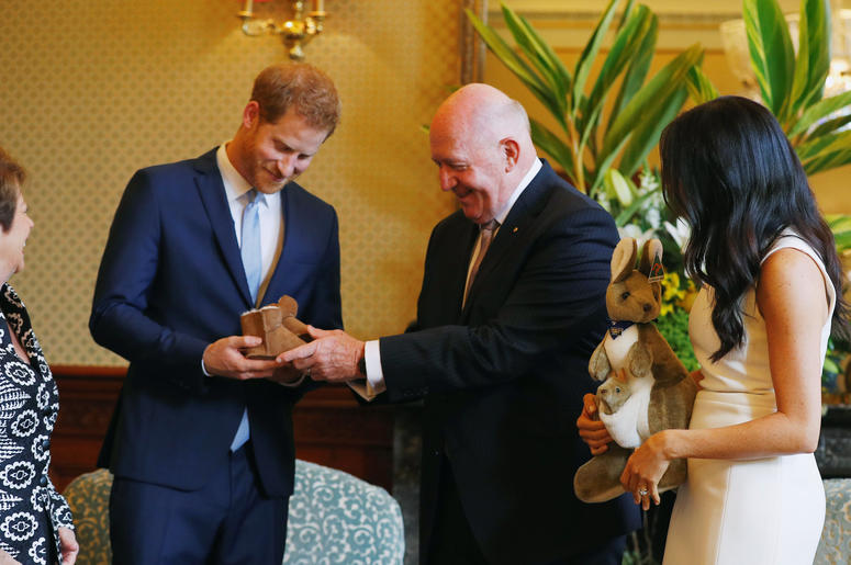 Australia's Governor General Peter Cosgrove and his wife Lynne Cosgrove give the Duke and Duchess of Sussex a toy kangaroo - with a baby - and a pair of children's boots at Admiralty House in Sydney on the first day of the royal couple's visit to Australi Australia's Governor General Peter Cosgrove and his wife Lynne Cosgrove give the Duke and Duchess of Sussex a toy kangaroo - with a baby - and a pair of children's boots at Admiralty House in Sydney on the first day of the royal couple's visit to Australi