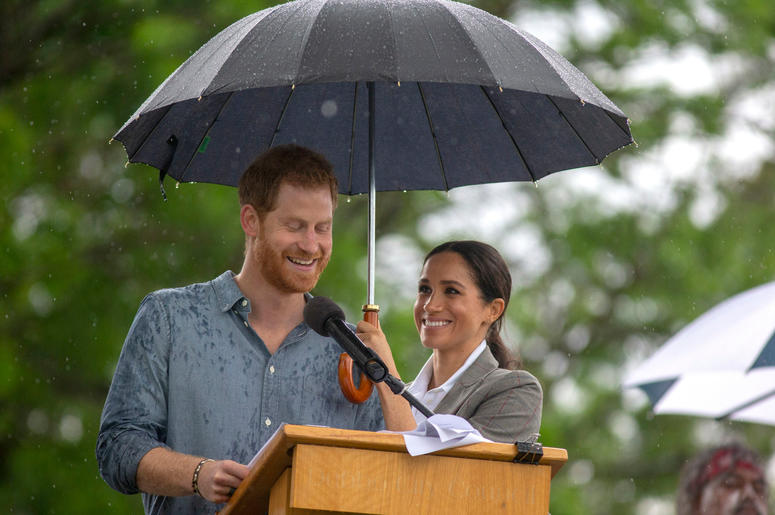 he Duchess of Sussex holds an umbrella as the Duke of Sussex makes a speech at a community picnic in Victoria Park in Dubbo, New South Wales, on the second day of the royal couple's visit to Australia he Duchess of Sussex holds an umbrella as the Duke of Sussex makes a speech at a community picnic in Victoria Park in Dubbo, New South Wales, on the second day of the royal couple's visit to Australia