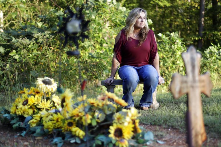Heather Melton sits by the grave of her husband, Sonny, on the grounds of their home in Tennessee Heather Melton sits by the grave of her husband, Sonny, on the grounds of their home in Tennessee