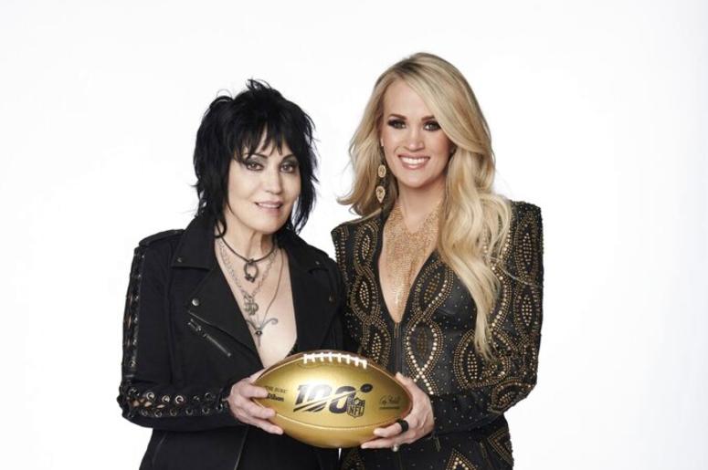 Joan Jett, left, and Carrie Underwood pose with a 100th anniversary NFL football. Joan Jett, left, and Carrie Underwood pose with a 100th anniversary NFL football.