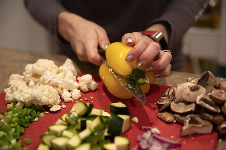Penny Shack chops vegetables for a vegan vegetable and tofu stir fry for lunch on Tuesday, Jan. 8, 2019, at her home in Chicago, Ill. Penny Shack chops vegetables for a vegan vegetable and tofu stir fry for lunch on Tuesday, Jan. 8, 2019, at her home in Chicago, Ill.