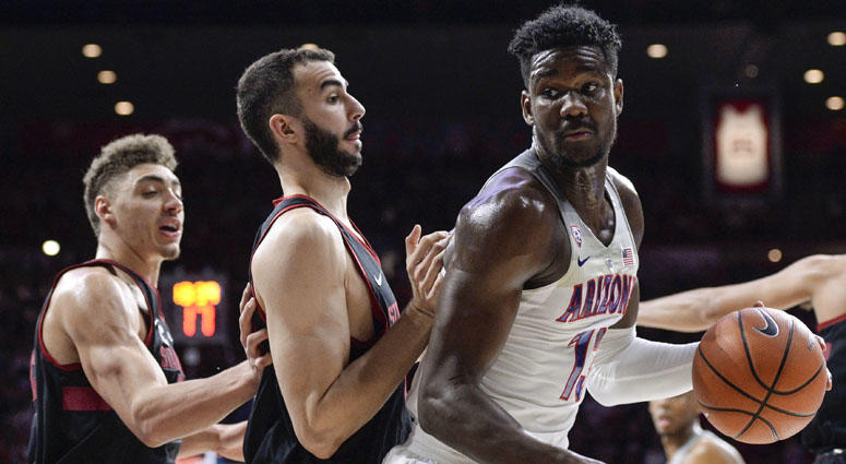 Arizona's Deandre Ayton is defended by a pair of Stanford players on March 1, 2018, at the McKale Center in Tucson, Arizona. Arizona's Deandre Ayton is defended by a pair of Stanford players on March 1, 2018, at the McKale Center in Tucson, Arizona.