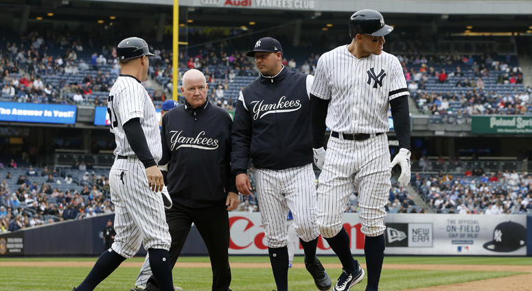 The Yankees' Aaron Judge is checked on by bench coach Josh Bard, trainer Steve Donohue and first-base coach Reggie Willits prior to leaving a game against the Kansas City Royals in the sixth inning at Yankee Stadium on April 20, 2019. The Yankees' Aaron Judge is checked on by bench coach Josh Bard, trainer Steve Donohue and first-base coach Reggie Willits prior to leaving a game against the Kansas City Royals in the sixth inning at Yankee Stadium on April 20, 2019.