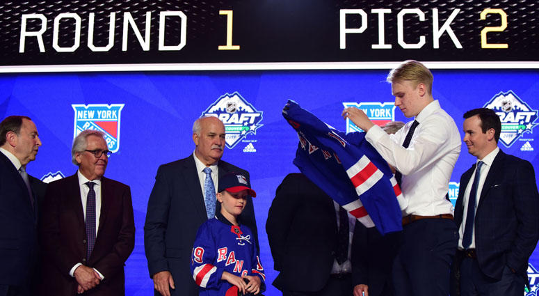 Kaapo Kakko puts on a team jersey after being selected as the No. 2 overall pick to the New York Rangers in the first round of the 2019 NHL Draft on June 21, 2019, at Rogers Arena in Vancouver, British Columbia. Kaapo Kakko puts on a team jersey after being selected as the No. 2 overall pick to the New York Rangers in the first round of the 2019 NHL Draft on June 21, 2019, at Rogers Arena in Vancouver, British Columbia.
