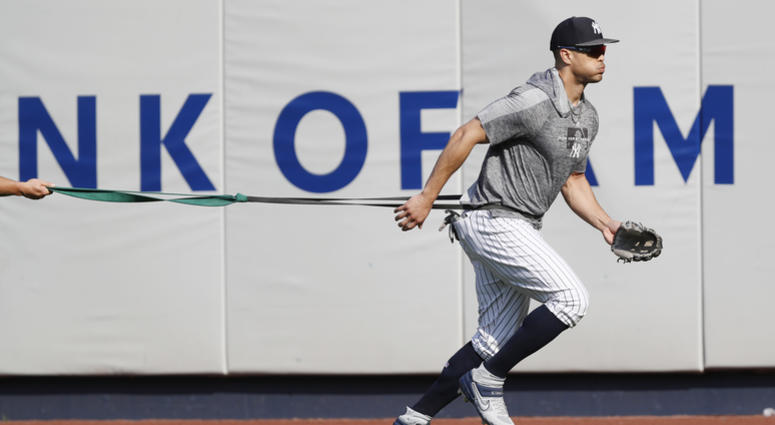 New York Yankees' Giancarlo Stanton, who has been out the much of the season with various injuries, trains with a resistance band in the outfield before a baseball game between the Yankees and the Texas Rangers, Wednesday, Sept. 4, 2019, in New York New York Yankees' Giancarlo Stanton, who has been out the much of the season with various injuries, trains with a resistance band in the outfield before a baseball game between the Yankees and the Texas Rangers, Wednesday, Sept. 4, 2019, in New York