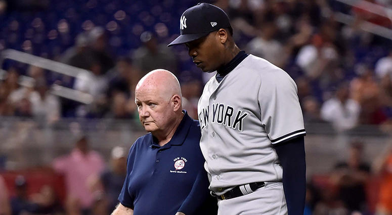 New York Yankees relief pitcher Aroldis Chapman leaves the game with a member of the medical staff in the twelfth inning after being injured during a game against the Miami Marlins Marlins Park on Aug 21, 2018. New York Yankees relief pitcher Aroldis Chapman leaves the game with a member of the medical staff in the twelfth inning after being injured during a game against the Miami Marlins Marlins Park on Aug 21, 2018.