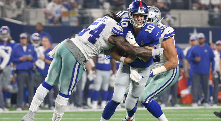 Eli Manning gets tackles on a run by Jaylon Smith at AT&T Stadium. Eli Manning gets tackles on a run by Jaylon Smith at AT&T Stadium.