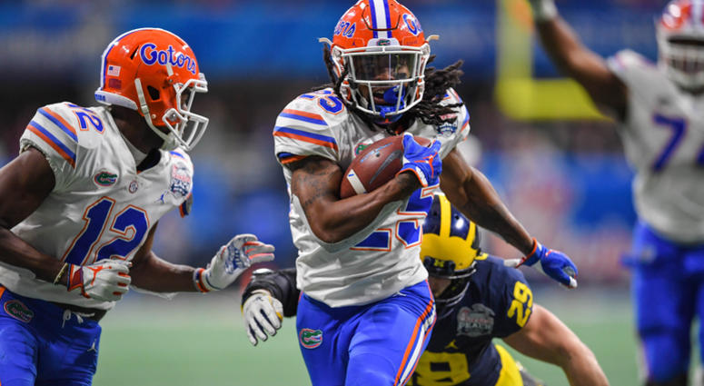 Dec 29, 2018; Atlanta, GA, USA; Florida Gators running back Jordan Scarlett (25) breaks tackles running with the ball against the Michigan Wolverines during the second half at Mercedes-Benz Stadium. Mandatory Credit: Dale Zanine-USA TODAY Sports Dec 29, 2018; Atlanta, GA, USA; Florida Gators running back Jordan Scarlett (25) breaks tackles running with the ball against the Michigan Wolverines during the second half at Mercedes-Benz Stadium. Mandatory Credit: Dale Zanine-USA TODAY Sports