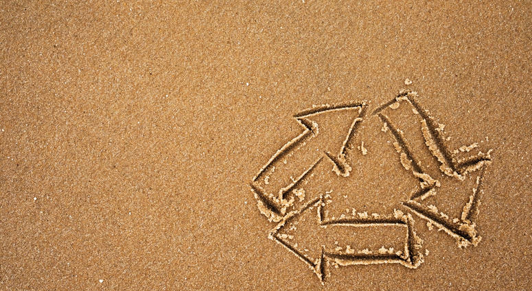 Recycle symbol on beach