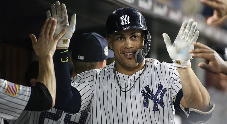 New York Yankees right fielder Giancarlo Stanton (27) is congratulated after hitting a home run in the eighth inning against the Atlanta Braves at Yankee Stadium on Jul 3, 2018. New York Yankees right fielder Giancarlo Stanton (27) is congratulated after hitting a home run in the eighth inning against the Atlanta Braves at Yankee Stadium on Jul 3, 2018.