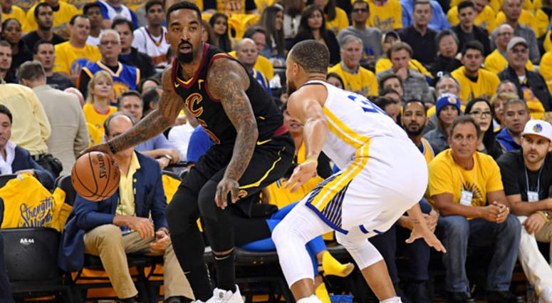 The Cavaliers' J.R. Smith dribbles while being defended by the Warriors' Stephen Curry. The Cavaliers' J.R. Smith dribbles while being defended by the Warriors' Stephen Curry.