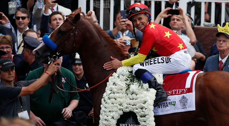 Mike Smith aboard Justify poses for photos in the winner circle after winning the 150th Belmont Stakes and Triple Crown at Belmont Park on June 9, 2018. Mike Smith aboard Justify poses for photos in the winner circle after winning the 150th Belmont Stakes and Triple Crown at Belmont Park on June 9, 2018.