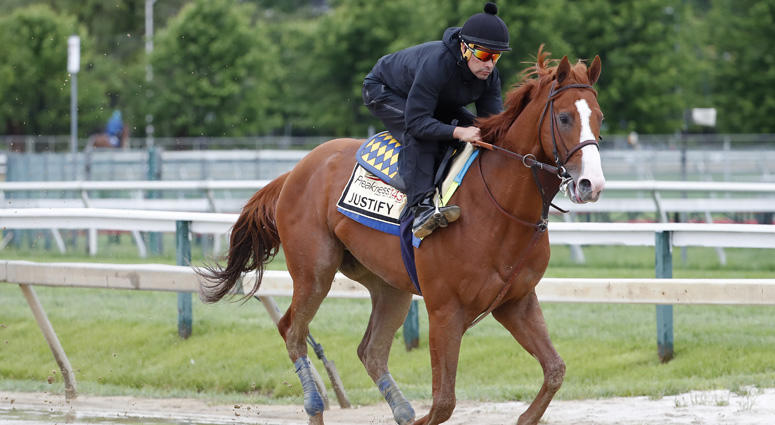 May 17, 2018; Baltimore, MD, USA; Kentucky Derby winner Justify, ridden by exercise rider Humberto Gomez, participates in a morning workout in preparation for the 143rd Preakness Stakes at Pimlico Race Course. Mandatory Credit:Geoff Burke-USA TODAY Sports
