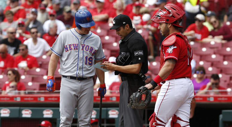 The Mets' Jay Bruce looks over the lineup card with home plate umpire Gabe Morales during the first inning on May 9, 2018, at Great American Ball Park in Cincinnati. The Mets' Jay Bruce looks over the lineup card with home plate umpire Gabe Morales during the first inning on May 9, 2018, at Great American Ball Park in Cincinnati.