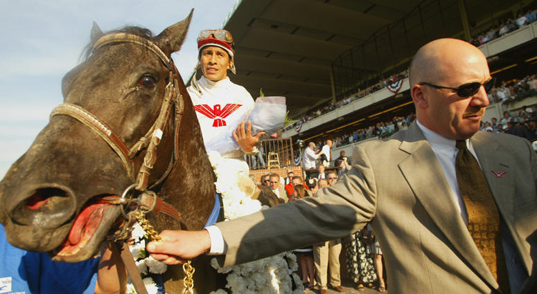 Sarava with jockey Edgar Prado is led to the winners' circle by trainer Kenneth McPeek after winning the 134th Belmont Stakes at Belmont Race Park on June 8, 2002. Sarava with jockey Edgar Prado is led to the winners' circle by trainer Kenneth McPeek after winning the 134th Belmont Stakes at Belmont Race Park on June 8, 2002.