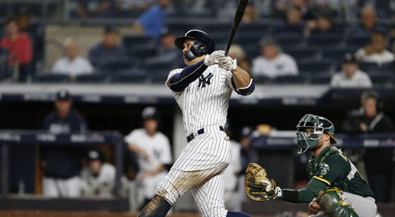 Yankees left fielder Giancarlo Stanton hits a solo home run during the eighth inning against the Oakland Athletics on Oct. 3, 2018, in a wild-card playoff game at Yankee Stadium. Yankees left fielder Giancarlo Stanton hits a solo home run during the eighth inning against the Oakland Athletics on Oct. 3, 2018, in a wild-card playoff game at Yankee Stadium.