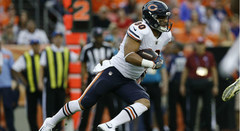 Trey Burton runs the ball in the first quarter against the Denver Broncos at Broncos Stadium at Mile High. Trey Burton runs the ball in the first quarter against the Denver Broncos at Broncos Stadium at Mile High.