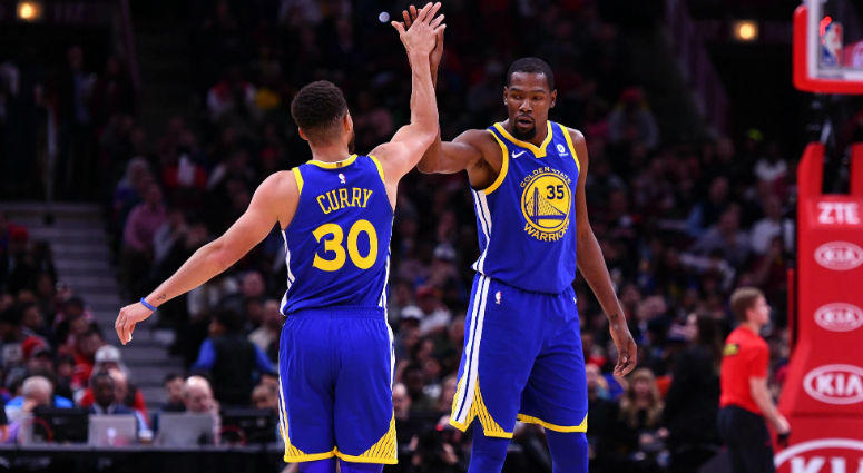 Stephen Curry reacts with Kevin Durant after making a three point basket against the Chicago Bulls during the second half at the United Center in Chicago. Stephen Curry reacts with Kevin Durant after making a three point basket against the Chicago Bulls during the second half at the United Center in Chicago.