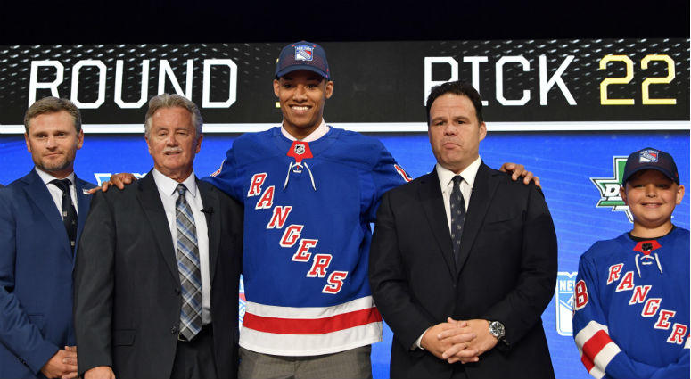 K'Andre Miller poses for a photo with team representatives after being selected as the number twenty-two overall pick to the New York Rangers in the first round of the 2018 NHL Draft at American Airlines Center. K'Andre Miller poses for a photo with team representatives after being selected as the number twenty-two overall pick to the New York Rangers in the first round of the 2018 NHL Draft at American Airlines Center.