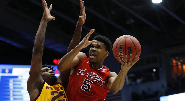 St. John's Red Storm guard Justin Simon (5) goes to the basket defended by Arizona State Sun Devils forward Romello White (23) in the first half in the First Four of the NCAA Tournament on March 20, 2019, in Dayton, Ohio. St. John's Red Storm guard Justin Simon (5) goes to the basket defended by Arizona State Sun Devils forward Romello White (23) in the first half in the First Four of the NCAA Tournament on March 20, 2019, in Dayton, Ohio.