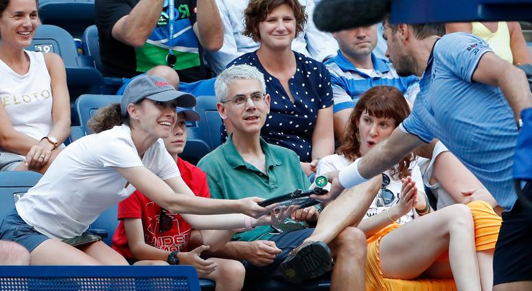 Stan Wawrinka hands his broken racquet to a fan. (USA TODAY Images)