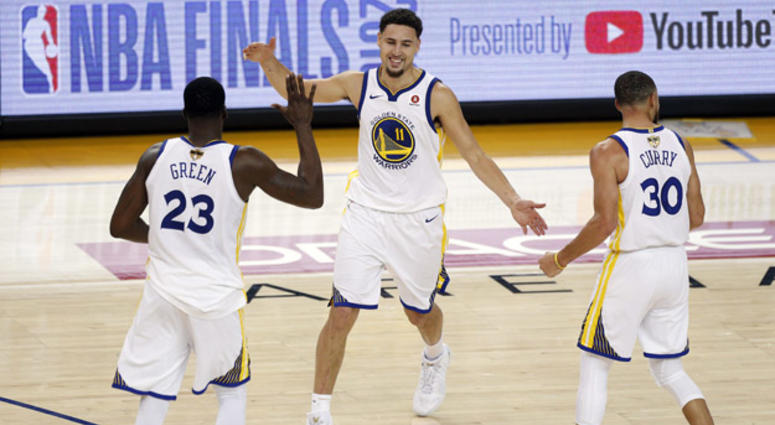Golden State Warriors guard Klay Thompson (11) reacts with forward Draymond Green (23) and guard Stephen Curry during overtime in Game 1 of the NBA Finals on May 31, 2018, at Oracle Arena in Oakland, California. Golden State Warriors guard Klay Thompson (11) reacts with forward Draymond Green (23) and guard Stephen Curry during overtime in Game 1 of the NBA Finals on May 31, 2018, at Oracle Arena in Oakland, California.