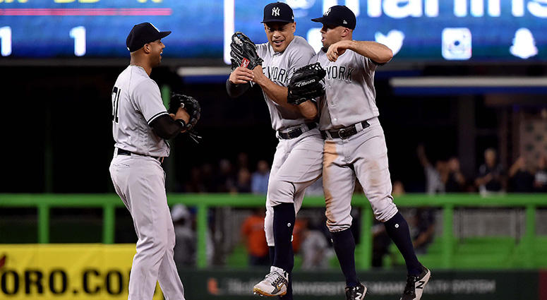New York Yankees right fielder Giancarlo Stanton (center) celebrates with Yankees left fielder Brett Gardner (right) and Yankees center fielder Aaron Hicks (left) after the Yankees defeating the Miami Marlins at Marlins Park on Aug 21, 2018. New York Yankees right fielder Giancarlo Stanton (center) celebrates with Yankees left fielder Brett Gardner (right) and Yankees center fielder Aaron Hicks (left) after the Yankees defeating the Miami Marlins at Marlins Park on Aug 21, 2018.