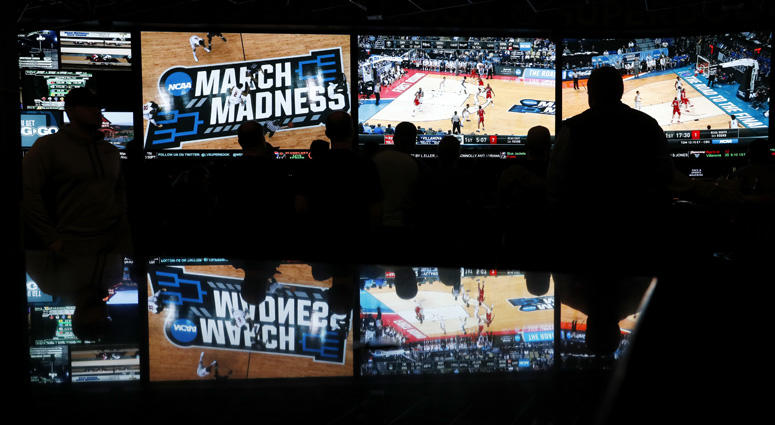 In this March 15, 2018 photo, people watch coverage of the first round of the NCAA college basketball tournament at the Westgate Superbook sports book in Las Vegas. In this March 15, 2018 photo, people watch coverage of the first round of the NCAA college basketball tournament at the Westgate Superbook sports book in Las Vegas.