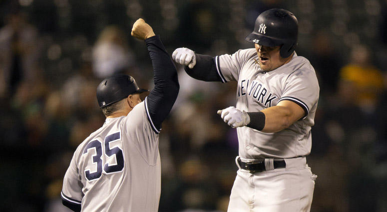 The Yankees' Luke Voit celebrates his solo home run with third-base coach Phil Nevin on Sept. 4, 2018, at Oakland Coliseum in Oakland, California. The Yankees' Luke Voit celebrates his solo home run with third-base coach Phil Nevin on Sept. 4, 2018, at Oakland Coliseum in Oakland, California.