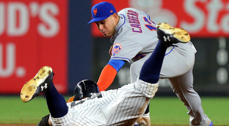 The Yankees' Aaron Judge (99) slides into second for a double ahead of a tag by Mets second baseman Asdrubal Cabrera on Aug. 15, 2017, at Yankee Stadium. The Yankees' Aaron Judge (99) slides into second for a double ahead of a tag by Mets second baseman Asdrubal Cabrera on Aug. 15, 2017, at Yankee Stadium.