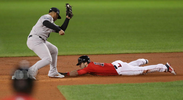 Red Sox left fielder Andrew Benintendi steals second base under Yankees second baseman Gleyber Torres during Game 1 of their ALDS on Oct. 5, 2018, at Fenway Park. Red Sox left fielder Andrew Benintendi steals second base under Yankees second baseman Gleyber Torres during Game 1 of their ALDS on Oct. 5, 2018, at Fenway Park.